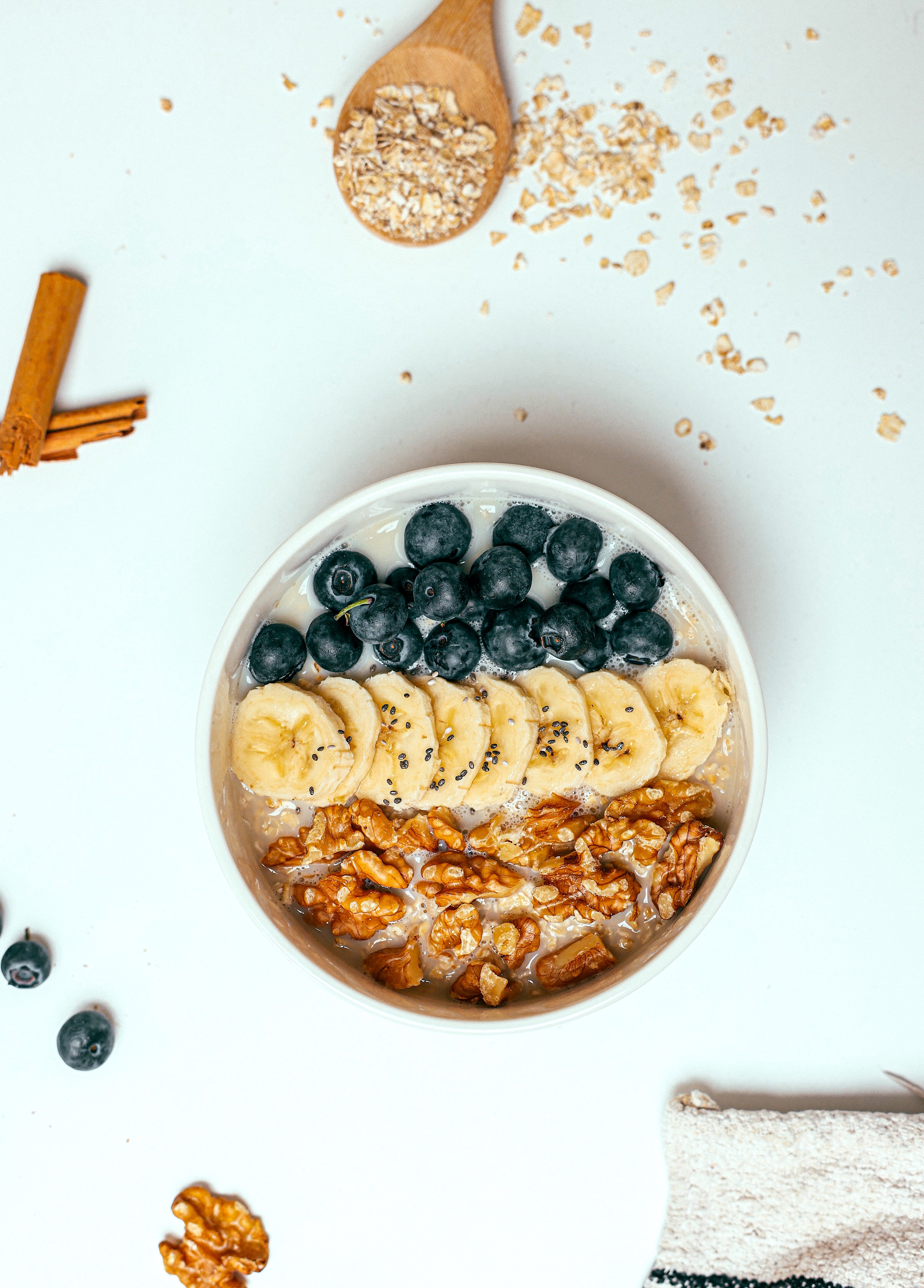 A Smoothie Bowl with Fresh Fruits Topping on a White Surface.